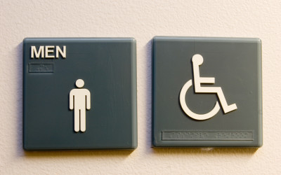 The Men's and Wheelchair sign on the entrance to the restroom.